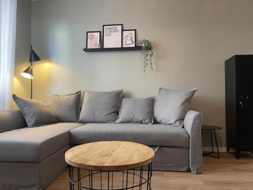 a living room with a couch and a coffee table at Le Cocon Urbain *T2* + Parking in Orléans