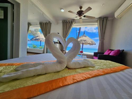 two swans made out of towels on a bed at Casa Beach Resort in Phan Thiet