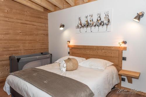 a bedroom with a bed and a wooden wall at Chalet Le Pourquoi Pas in La Bresse