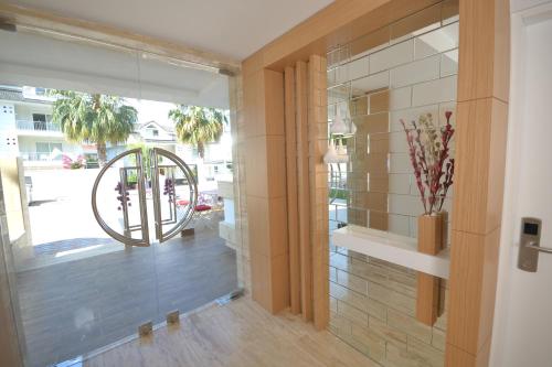 a hallway with a glass door and a window at Doc's Hotel Kemer in Kemer