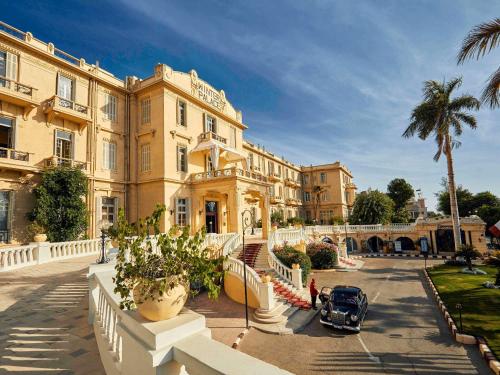 a building with a car parked in front of it at Sofitel Winter Palace Luxor in Luxor