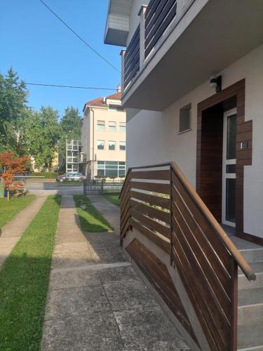 a wooden fence next to a building at COMFORT Suites VELIKA GORICA in Velika Gorica