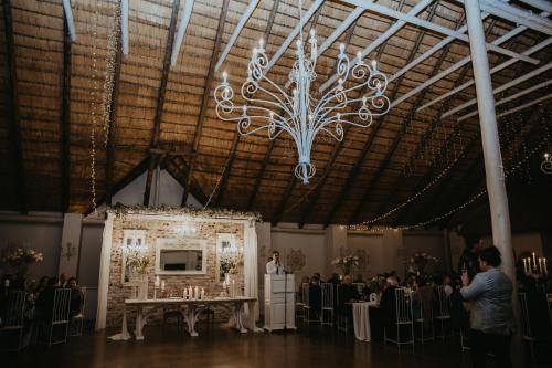 a large room with a chandelier hanging from the ceiling at Siesta Guesthouse & Wedding Venue - Frankfort in Frankfort