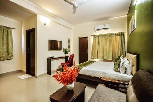 a hotel room with a bed and a couch at The Park Classic Udaipur in Udaipur
