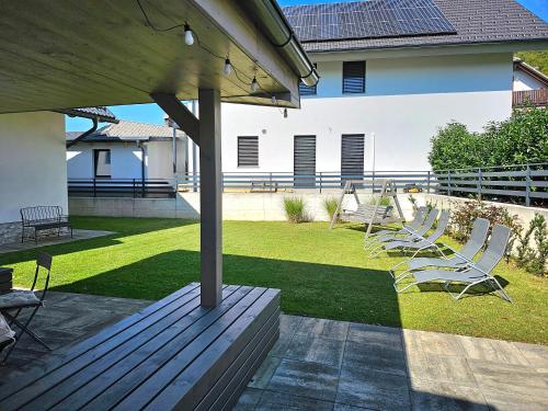 a group of chairs sitting on top of a patio at Prima Countryside Apartments in Žirovnica