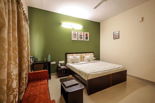 a bedroom with a bed and a green wall at The Park Classic Udaipur in Udaipur