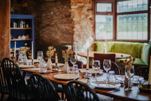 a dining room with a long table with wine glasses at Hanley House in Tenbury