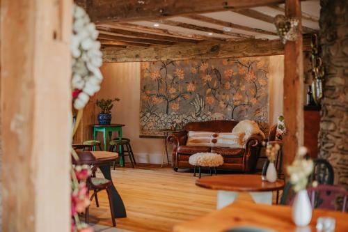 a living room with a couch and a wall at Hanley House in Tenbury