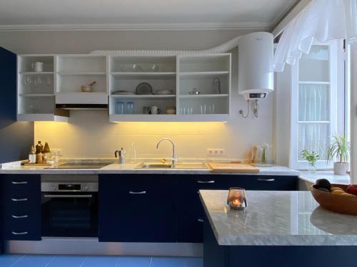 una cocina con armarios azules y fregadero en Villa Finca El Drago, en La Orotava