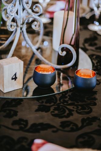 two candles sitting on a table with a mirror at Siesta Guesthouse & Wedding Venue - Frankfort in Frankfort