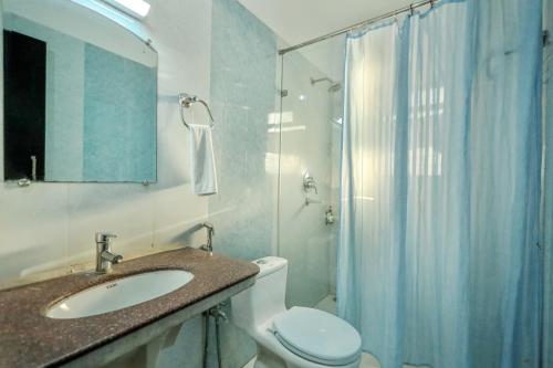 a bathroom with a toilet and a sink and a shower at The Park Classic Udaipur in Udaipur