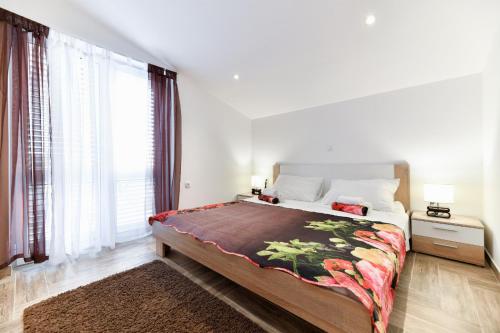 a bedroom with a large bed and a large window at Villa Bella in Kruševo