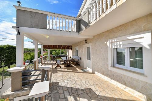 a patio of a house with a balcony at Villa Bella in Kruševo