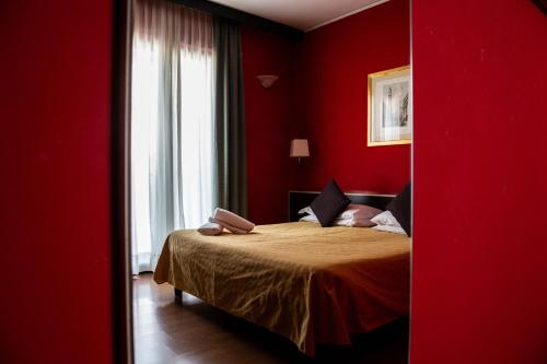 a red bedroom with a bed in a red room at Hotel Berlino in Milan