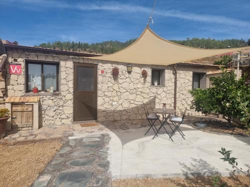 a stone house with a tent in front of it at Casa Luis Pico in Granadilla de Abona