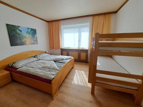 a bedroom with two bunk beds and a window at Appartement Eigelsreiter Lilienfeld in Lilienfeld