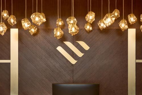 a sign that says new hanging from a wall with lights at Grand Hotel Palace in Thessaloniki