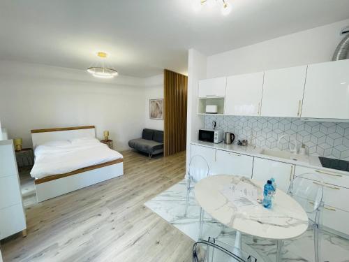 a kitchen and living room with a bed and a table at Apartment Barrier-Free in Kraków