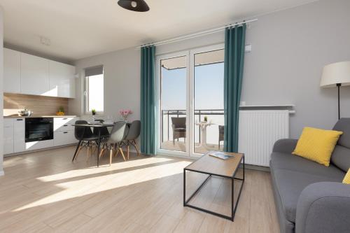 a living room with a couch and a table at Beautiful & Quiet Studio Szeligowska by Noclegi Renters in Warszawa
