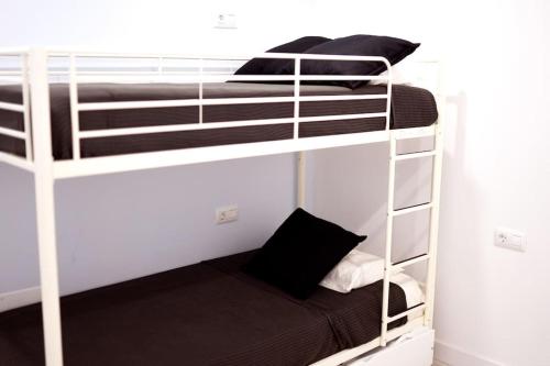 a couple of bunk beds in a room at Apartamento primera línea mar Garachico in Garachico