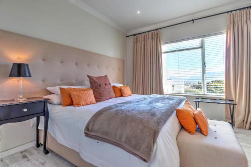 a bedroom with a large bed and a window at Thyme Wellness Spa and Guesthouse in Cape Town