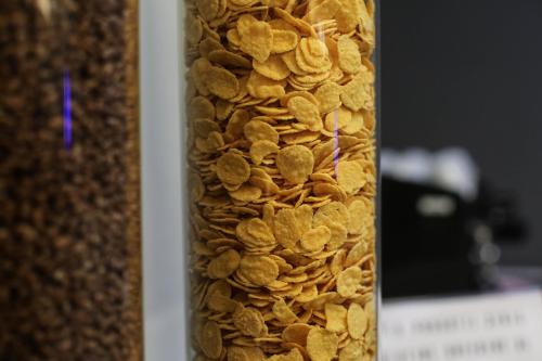 a tall glass jar filled with dried peanuts at Hotel Berlino in Milan