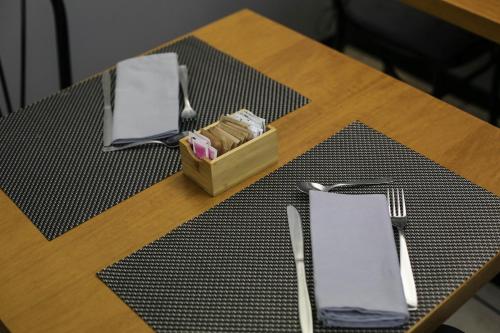 a table with a napkin and a box of napkins at Hotel Berlino in Milan