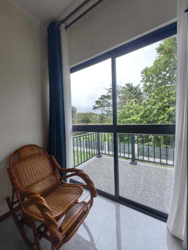 a wicker chair sitting in front of a large window at coral coast FIJI in Sigatoka
