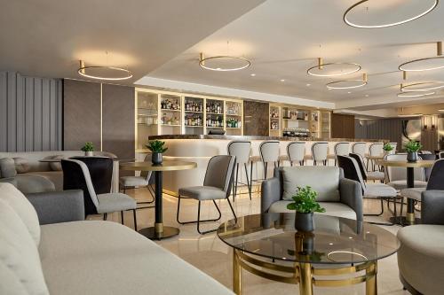 a restaurant with tables and chairs and a bar at Grand Hotel Palace in Thessaloniki
