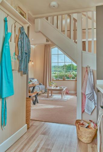 a room with a staircase and a living room at The Pump House At Wiston Estate in Ashington