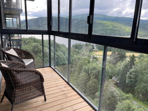 a balcony with two chairs and a view of the mountains at Åre Travel - View in Åre