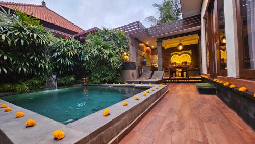 a house with a swimming pool in a courtyard at Ubud Paradise Villa in Ubud