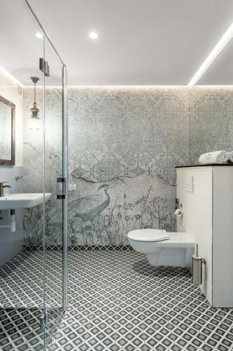 a bathroom with a shower and a toilet and a sink at Tawerna Kaszubska in Ostrzyce