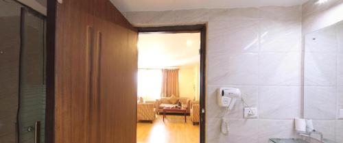 Hotel Mirage Regency في كاتماندو: حمام مع هاتف على الحائط وغرفة معيشة