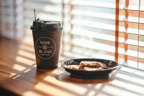 a cup of coffee and a bowl of food on a table at Twin Hotel Kampot in Kampot
