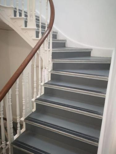 a staircase with white railings and grey steps at Central Bridgewater Flat in Bridgwater