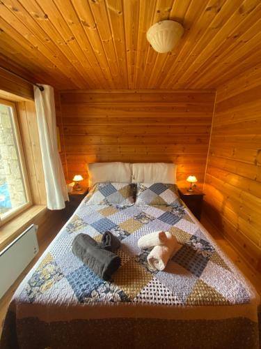 a bedroom with a bed in a wooden cabin at Beautiful Chalet on Mt. Parnassos near ski resort in Kalánia