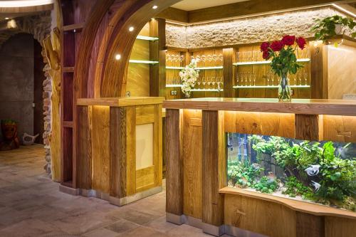 a room with a counter with a vase of flowers at Hotel Kocourkov in Hlinsko