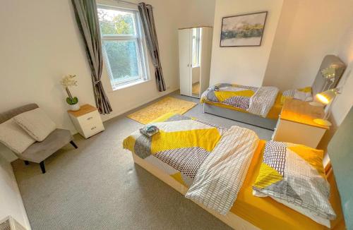 a bedroom with two beds and a chair and a couch at Long term offers Message for prices Sleeps 6 Adults, Contractors, Relocators, Travellers in Halifax