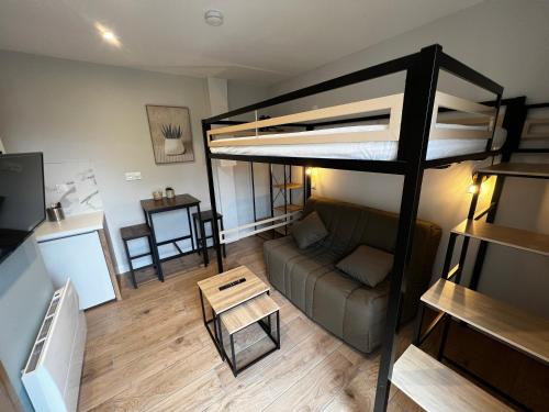 a living room with a loft bed and a couch at Scorfel Lodge, Studio 52, GR34, terrasse & calme in Trégastel