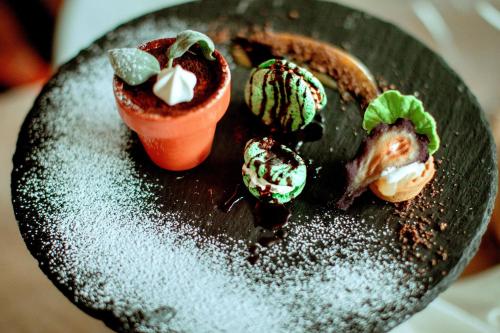 a black plate with some food on it at Sotto Il Cielo Hotel in Pignola