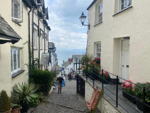 people walking down a cobblestone street between buildings at Bedport Loft in Burrington