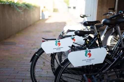 a group of bikes parked on a sidewalk at Good Morning+ Malmö in Malmö