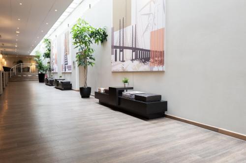 a hallway with potted plants in a building at Good Morning+ Malmö in Malmö