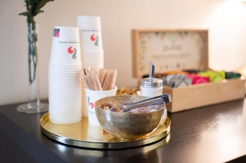 a table with a bowl of food on a table at Good Morning+ Malmö in Malmö