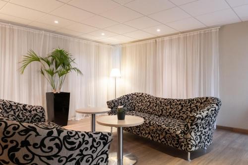 a living room with two couches and a table at Good Morning+ Malmö in Malmö