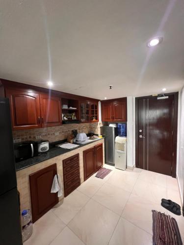 a kitchen with wooden cabinets and a stainless steel refrigerator at Cubic P 1902 in Cebu City