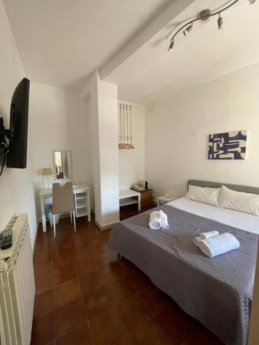a bedroom with a bed and a desk and a television at 100 PASSI Politeama in Palermo
