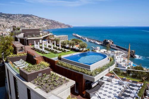 an aerial view of a building with a swimming pool at The Reserve - The Leading Hotels of the World - Savoy Signature in Funchal