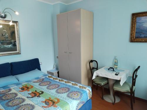 a bedroom with a bed and a table and a cabinet at B & B Ametista Bergamo in Ponteranica